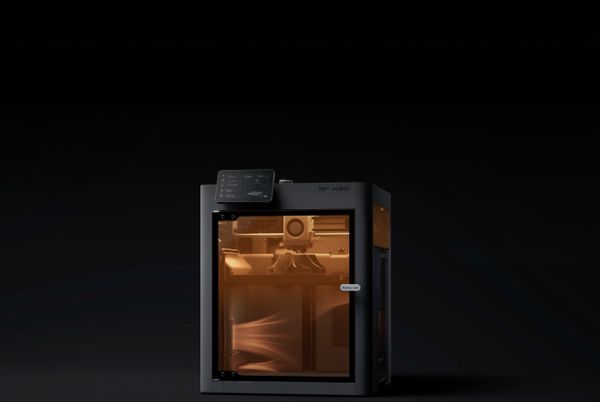 Bambu Lab X2D with active heated chamber glowing orange