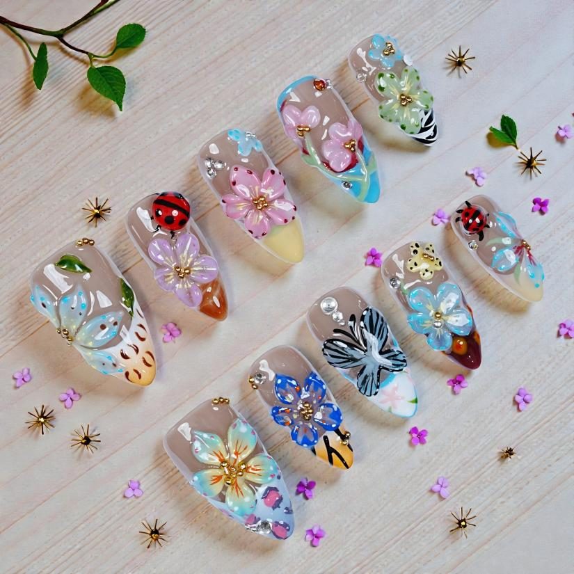 Hand-finished sculptural press-on nails with raised flowers and charms