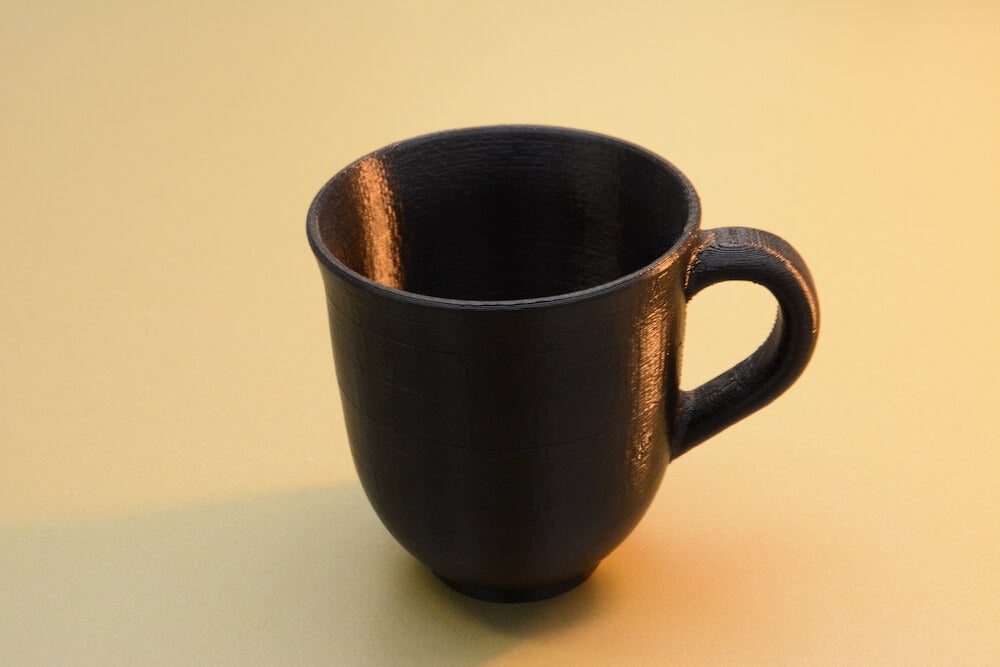 3D printed mug showing visible layer lines